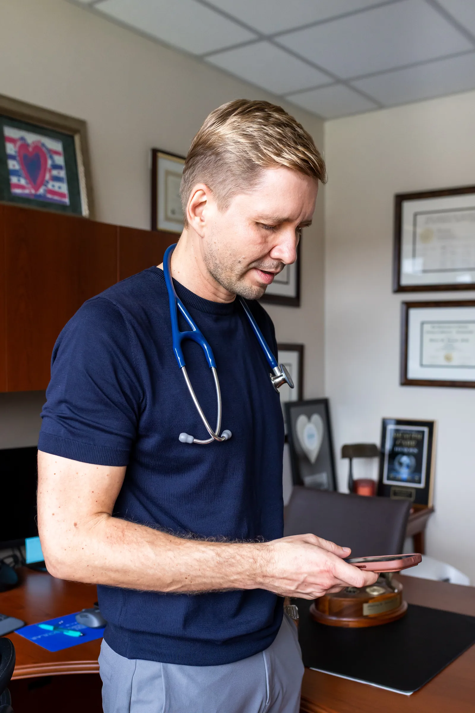Dr. Yaranov in his office, looking at his phone