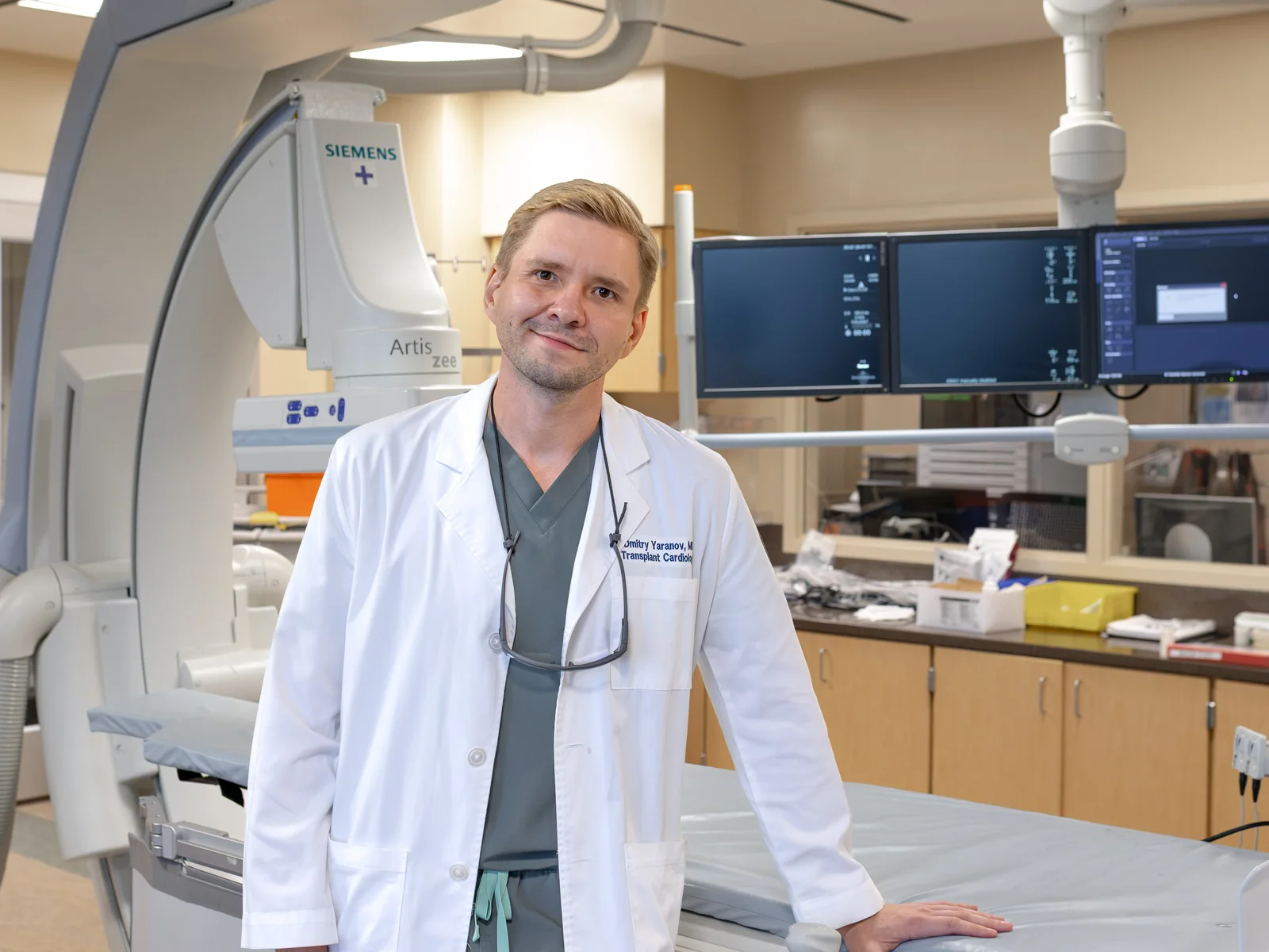 Dr. Yaranov in a white coat beside the cath lab table