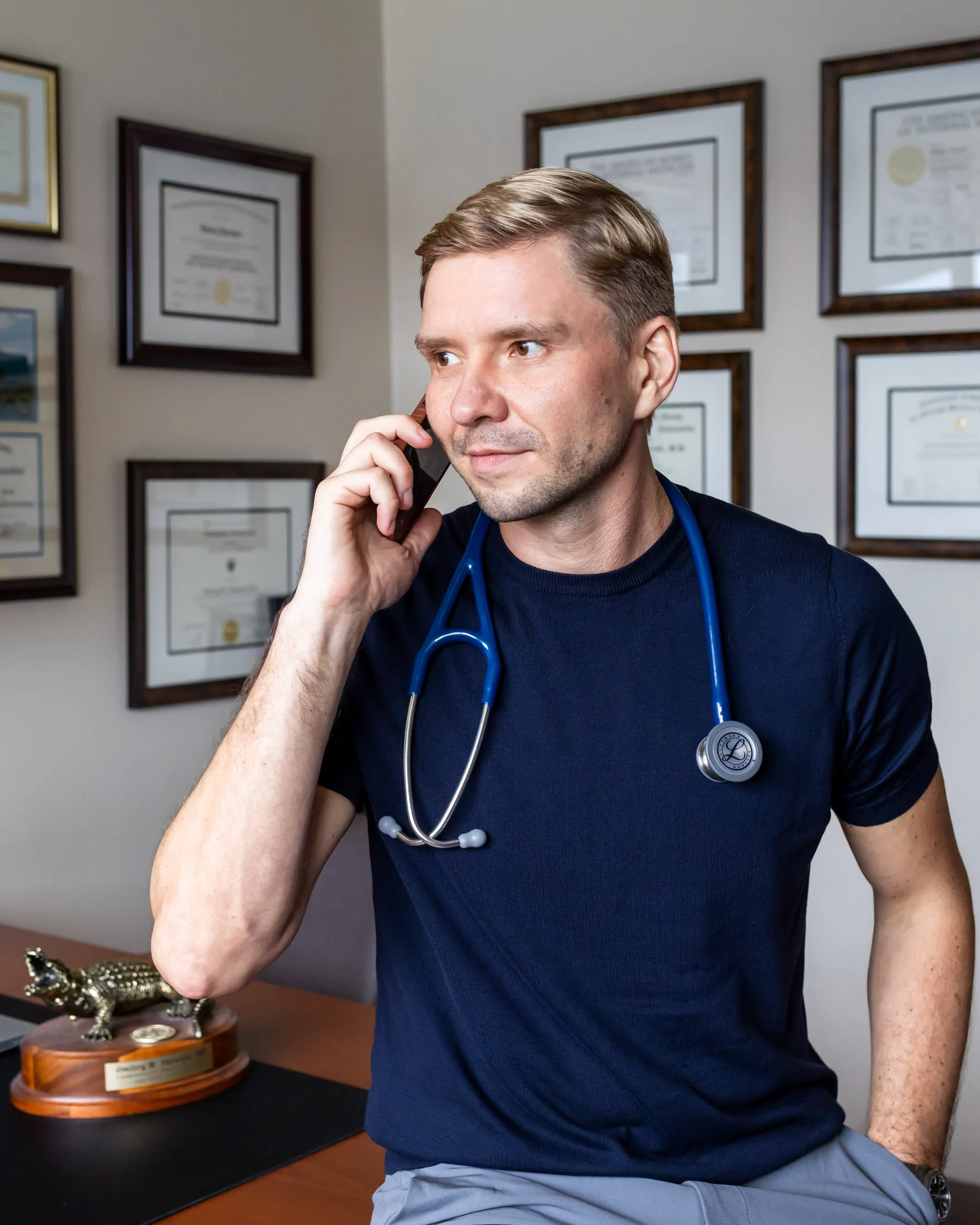 Dr. Yaranov at his desk in a navy shirt, on a phone call